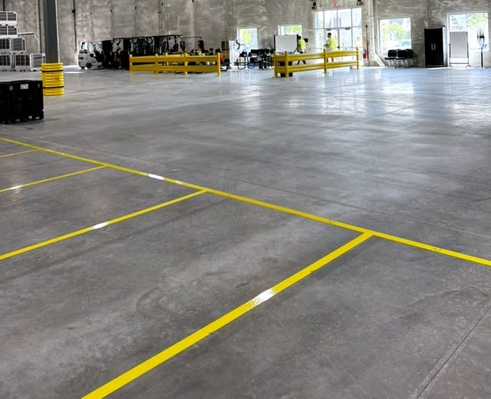 Clean concrete warehouse floor with yellow lane lines in Hammond, Indiana