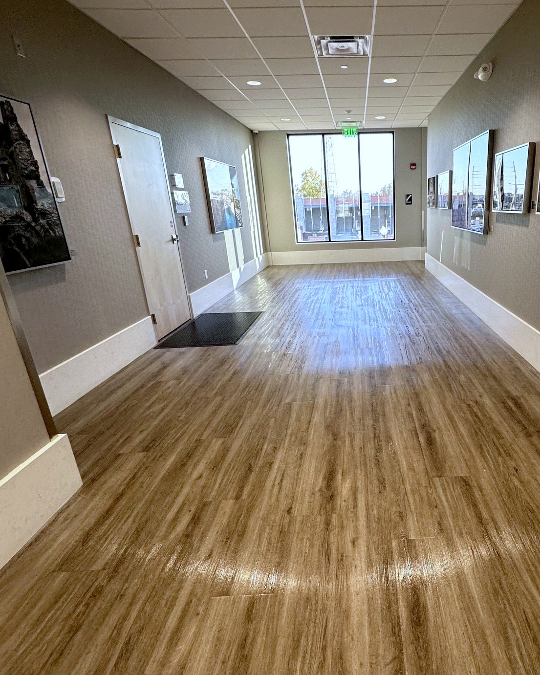 Medical office corridor in Munster, Indiana, with freshly cleaned plank floors and framed art