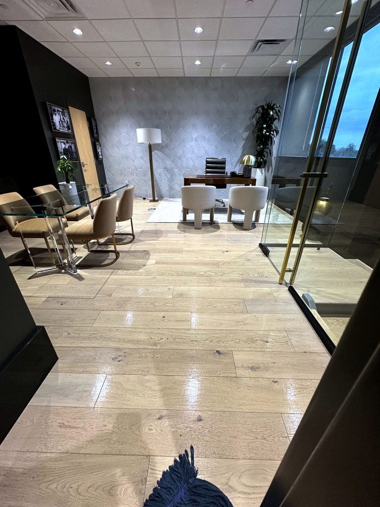 Private office in Munster, Indiana, with a glass wall and polished wood floors