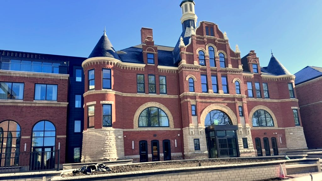 Restored brick building with a historic tower and a new wing in Valparaiso, Indiana, after our post construction cleaning